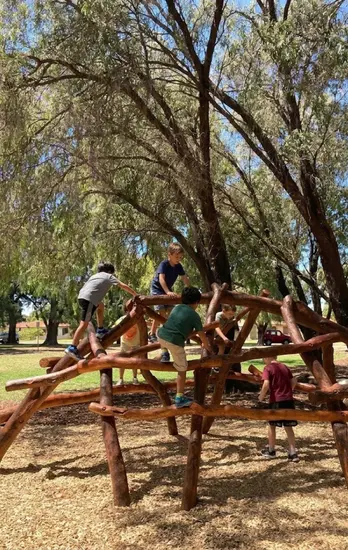 Children playing in a Skywalker bespoke natural timber playground