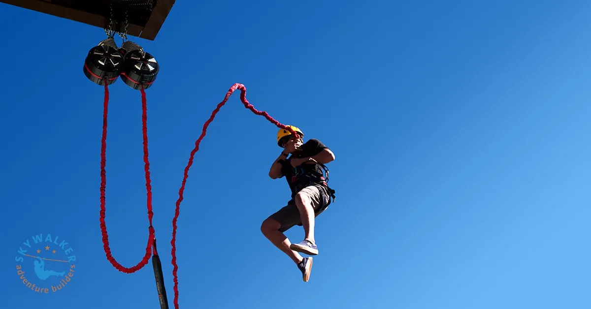 Participant experiencing a free fall device from an elevated platform